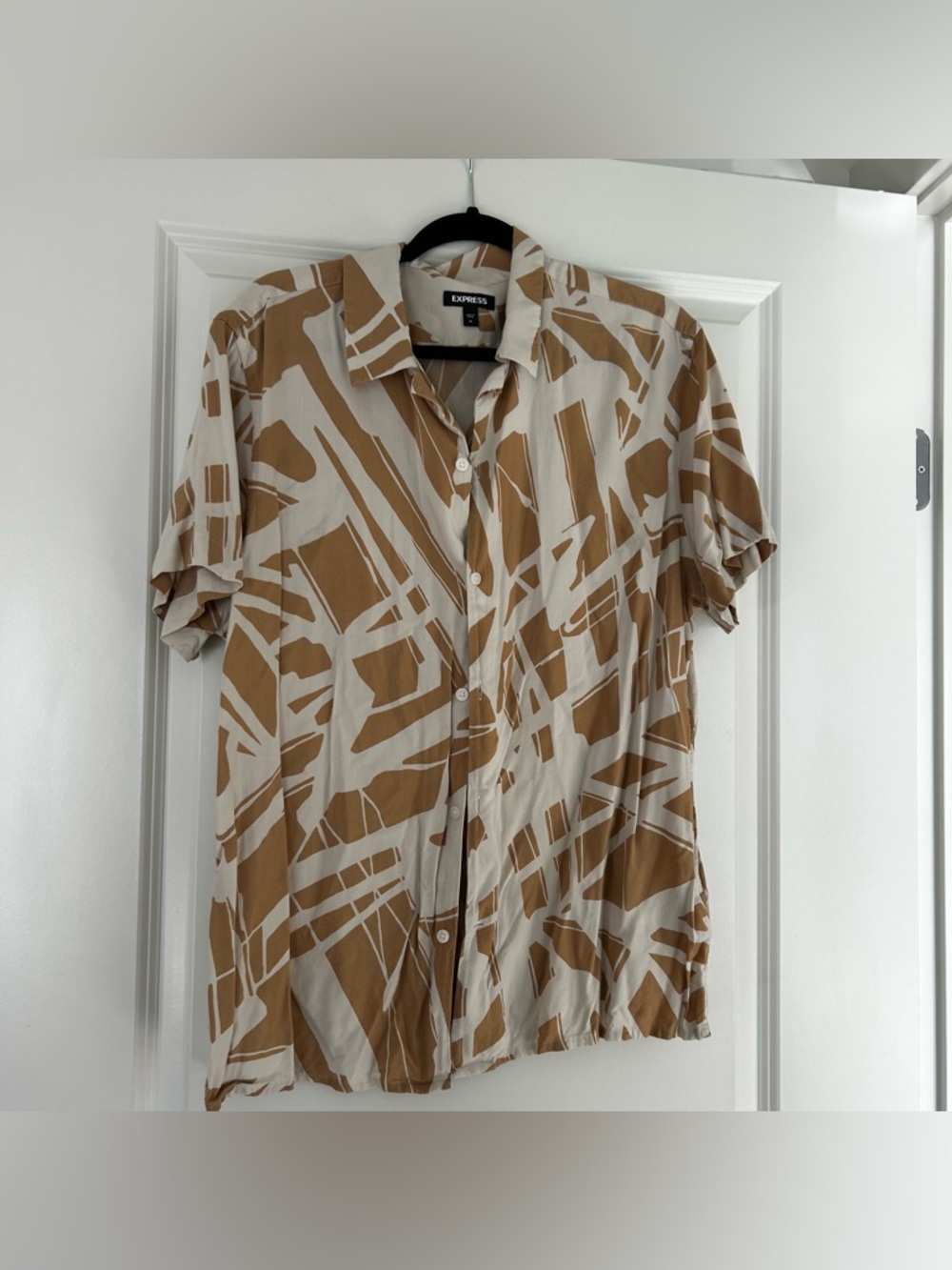 Tan and white Express button-up abstract shirt
Threads lose in one spot